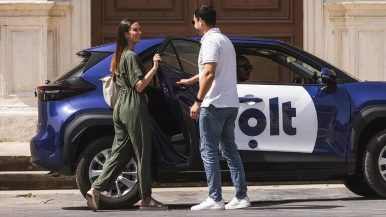 two people infront of a car