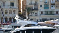 A yacht parked with Birgu Waterfront in the background