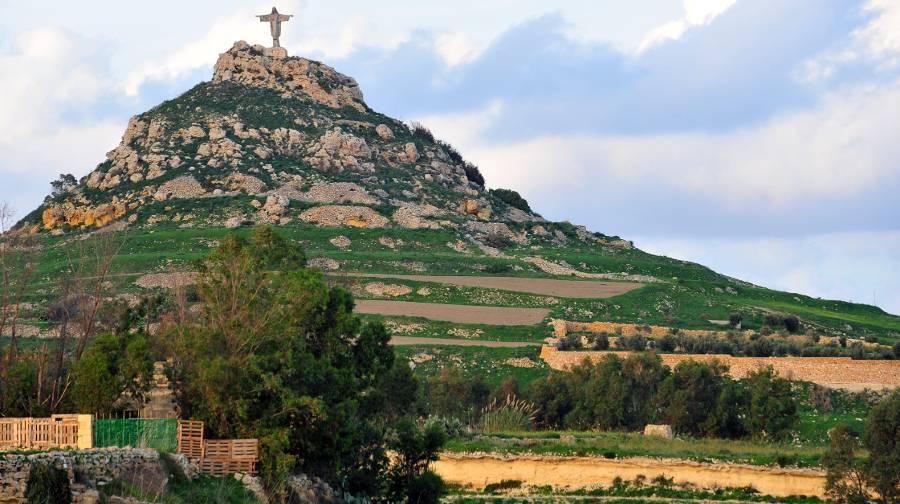 Tas Salvatur Hill in Gozo - a rocky hill with a statue of Christ the Redeemer atop