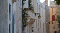 A balcony in Mdina with greenery spilling over the top