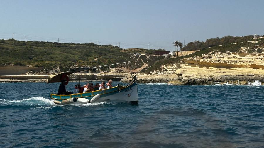 A Maltese water taxi taking a tour along the southern coast of Malta