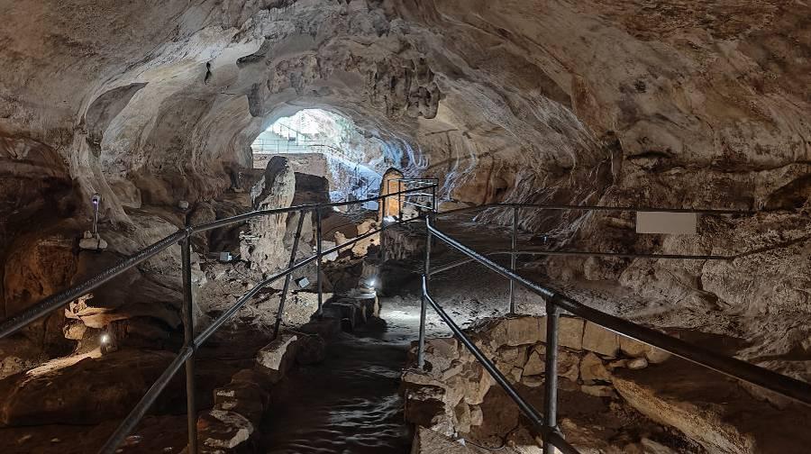 the exit out of Ghar Dalam cave with railing outlining the path and stairs leading out