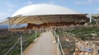 A road up to a cluster of old Maltese temples under a protective cover